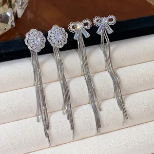 Elegant silver-toned dangle earrings featuring bow and flower studs with long tassels