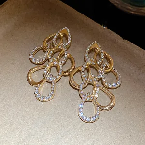 Exquisite gold-plated twisted water drop earrings with shimmering rhinestones detail