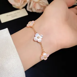 Elegant pink mother-of-pearl flower bracelet with gold chain and central zircon detailing