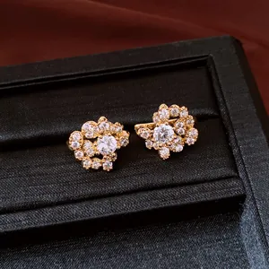 Elegant detail view of sparkling cubic zirconia flower stud earrings in a black luxury box