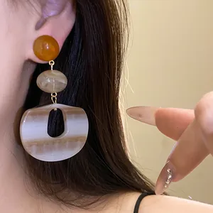 Detailed view of vintage marbled acrylic oval drop earrings with three-tier design
