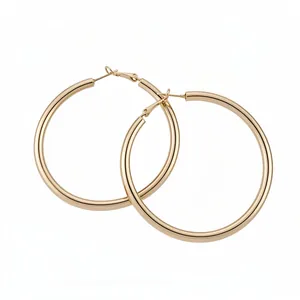 Elegant gold-tone metal hoop earrings with a minimalist round design for women.