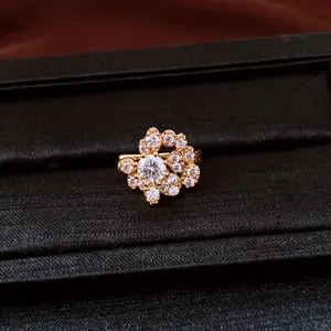 Macro view of sparkling round cubic zirconia clusters on a luxury gold-tone ear clip accessory