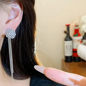Detailed close-up view of silver zircon flower earrings featuring long elegant chain tassels