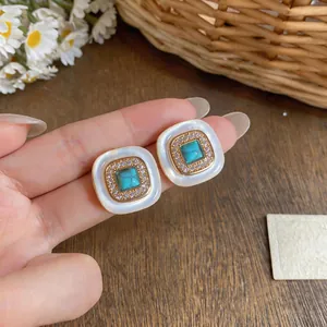 Detailed view of French retro geometric square stud earrings with turquoise and zirconia inlay
