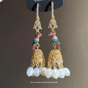 Elegant parrot tassel earrings featuring white pearls and shimmering colorful rhinestones