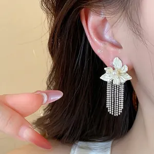 Elegant silver flower stud earrings with long tassels and a central pearl accent
