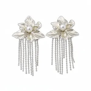 Elegant silver flower tassel earrings with white pearls on a clean white background.