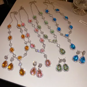 Detailed view of colorful teardrop and oval crystal necklace sets with matching earrings