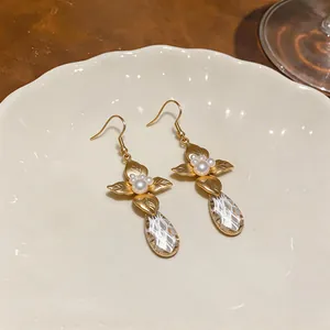 Detail of elegant French vintage gold leaf earrings with pearls and teardrop crystals