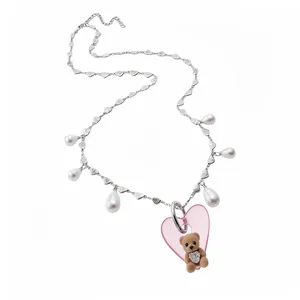 Elegant vintage pearl necklace with a cute flocked teddy bear and pink heart pendant.