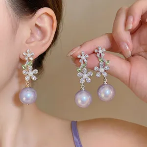 Elegant French style flower earrings featuring purple pearls and sparkling zircon details.