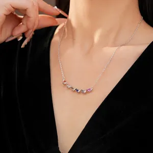 Elegant minimalist silver twisted necklace featuring colorful zircon stones on model neck