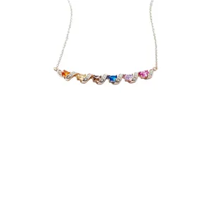 Elegant rose gold necklace with colorful stones and twisted zirconia bar design