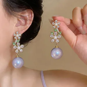 French luxury zircon flower drop earrings with large lavender pearls worn by an Asian model