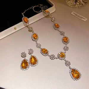 Detail of luxury orange teardrop gemstone jewelry set with sparkling rhinestones