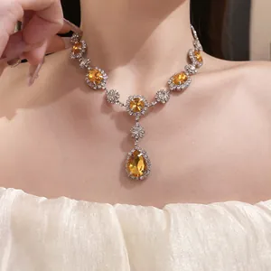 Detailed view of an elegant necklace with amber crystals and sparkling rhinestones.