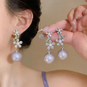 Elegant French style zircon flower earrings featuring large purple pearl drops detail.