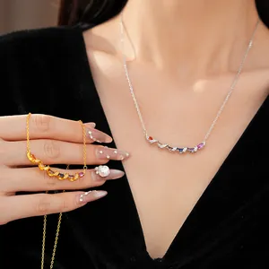 Detailed view of twisted necklace with multi-color zircon stones in gold and silver