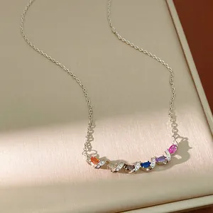 Close-up of twisted silver necklace with multi-colored marquise zircon stones.