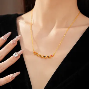 Close-up of twisted gold necklace featuring vibrant multi-colored zircon stones.