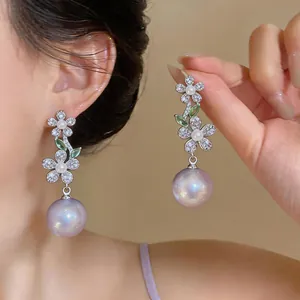 Detailed close-up of elegant French flower drop earrings with zircon and lavender pearl