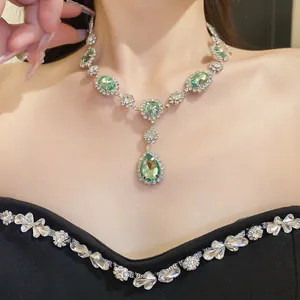 Elegant crystal necklace with green teardrop and oval gemstones for evening wear