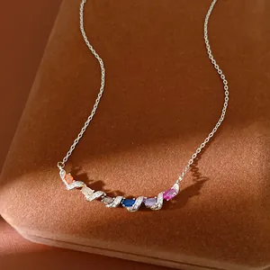 Detailed view of silver necklace with colorful stones in twisted zircon setting