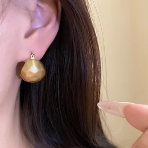 Detailed wearing display of vintage gold brushed semi-circular ear cuff earrings for women