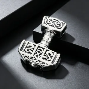Detailed view of stainless steel Mjolnir pendant with intricate Celtic knot patterns