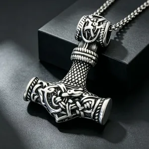 Close-up detail of Mjolnir pendant featuring intricate Norse engravings and vintage finish