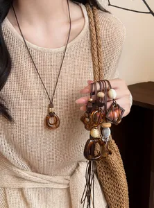 Detailed view of vintage amber resin pendants on brown leather cord necklaces