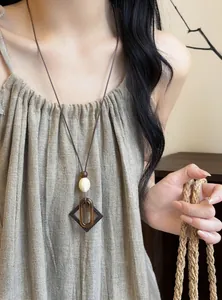 Retro ethnic style necklace featuring resin oval pendant on a leather cord for women