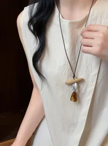 Detail of a retro ethnic style necklace with amber resin pendant and wooden bead