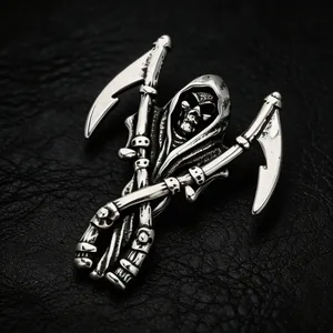 Detailed view of dark style grim reaper pendant with crossed scythes on leather background.