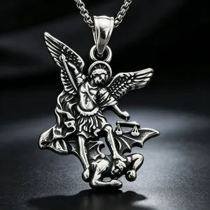 Detailed close-up of a silver Saint Michael pendant defeating a demon on a chain.