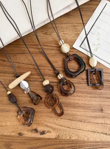 Detail of vintage resin pendants on leather cords for ethnic style sweater necklaces.
