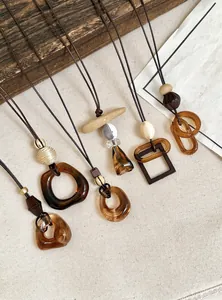Detail of vintage ethnic style resin and acrylic pendant necklaces with leather cord