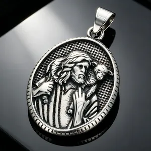 Detailed macro view of a silver Jesus Good Shepherd metal pendant with fine relief carving.
