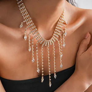 Close-up detail of luxury gold tassel necklace with shimmering rhinestone water-drops.
