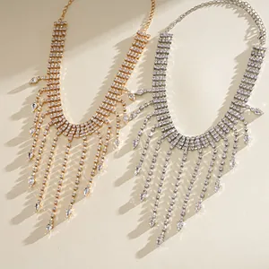 Close-up of gold and silver rhinestone necklaces with elegant teardrop tassel details.