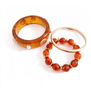 Elegant three-piece set of vintage amber resin shell bangles and beaded bracelets for women