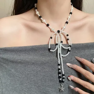 Elegant French retro stainless steel necklace featuring glass pearls and a bowknot star tassel