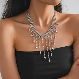 Close-up of an exquisite rhinestone teardrop tassel necklace on a female model's neck