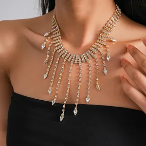 Close-up of golden rhinestone fringe necklace with teardrop crystal pendants