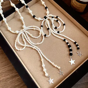 Detailed view of vintage pearl bow tassel necklaces featuring stainless steel stars
