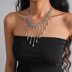 Elegant detail view of a luxury rhinestone teardrop fringe necklace on a model.