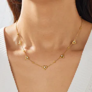Exquisite gold-plated stainless steel necklace featuring heart pendants on model's neck