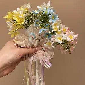 Romantic dopamine-style colorful flower hair clip with delicate ribbons and pearls.