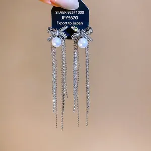 Elegant S925 silver needle bow-knot earrings featuring long crystal tassels and pearls